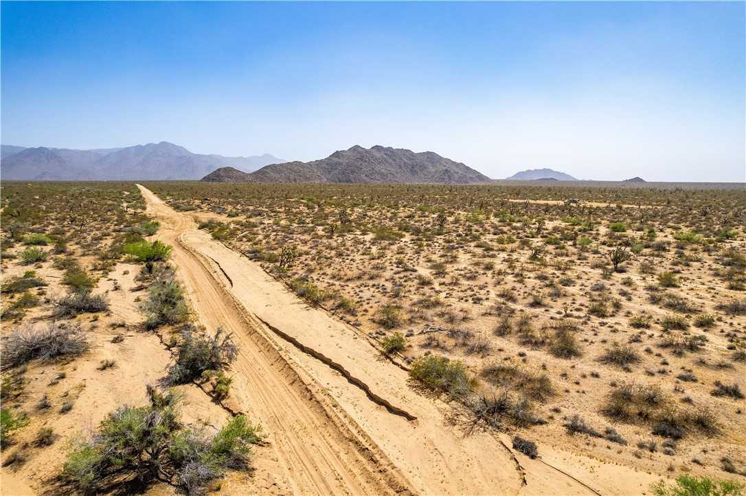 0 East Arroyo Road Yucca, AZ 86438 - Photo 18 of 25 Expansive desert landscape featuring a dirt path and distant mountain ranges