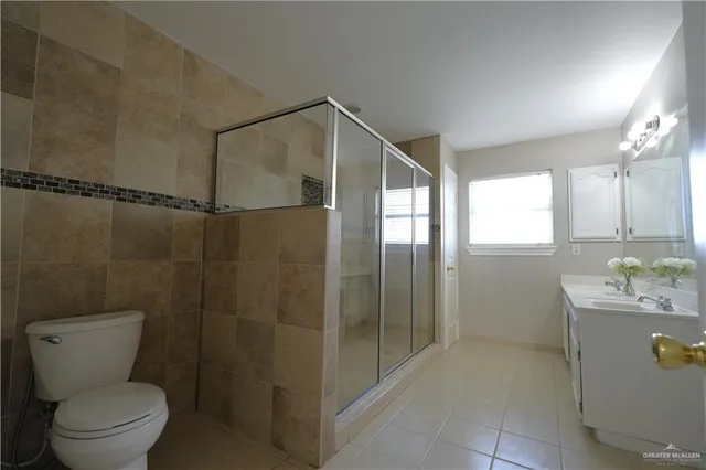 a bathroom with a toilet sink and shower