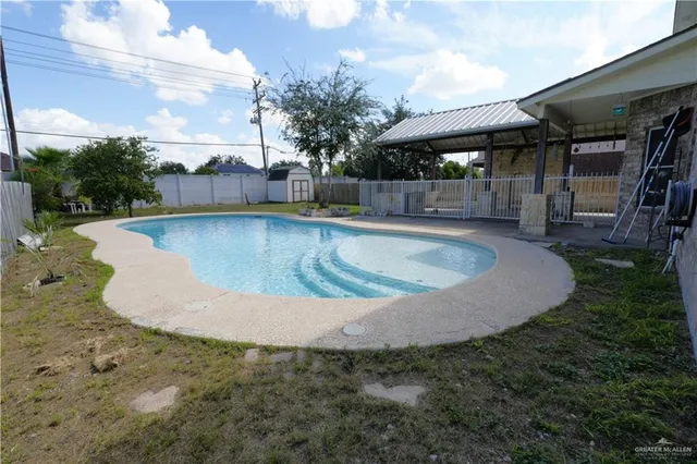 a view of a swimming pool with a yard