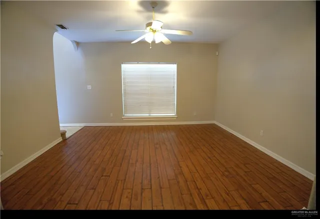 wooden floor in an empty room with a window