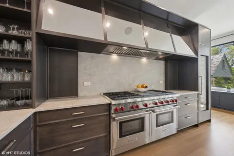 a kitchen with stainless steel appliances and white cabinets