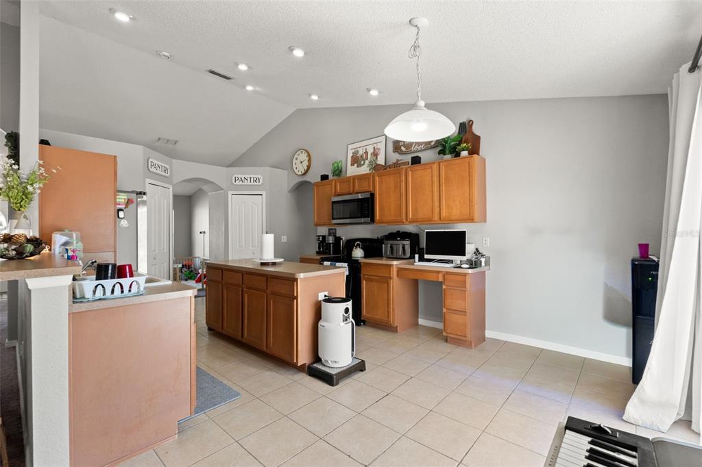 15335 Fleetwood Road Weeki Wachee, FL 34614 - Photo 21 of 40 a kitchen with stainless steel appliances granite countertop a stove top oven a sink dishwasher and a refrigerator