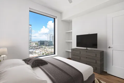 a bedroom with a bed and a television