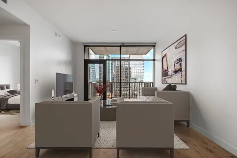 a living room with furniture and large windows