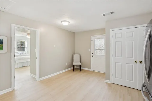 an empty room with windows and furniture