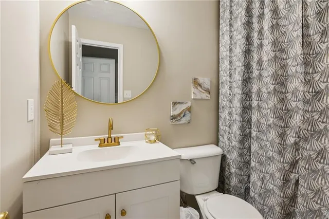 a bathroom with a sink mirror and toilet