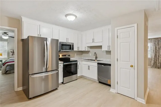 a kitchen with a refrigerator stove and sink