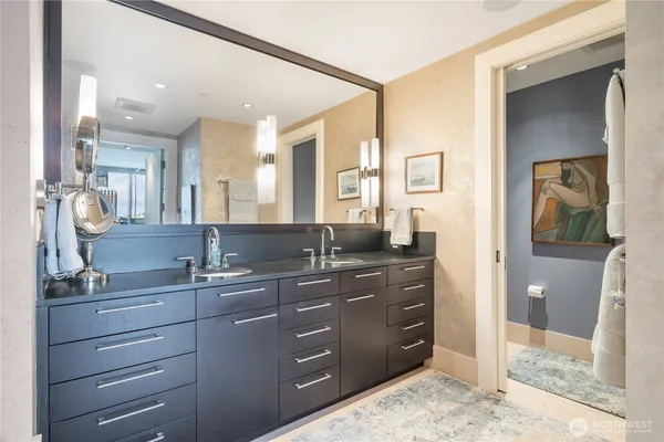 a bathroom with a sink a vanity and a mirror