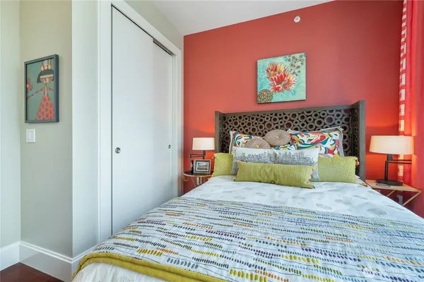 a bedroom with a bed and wooden floor