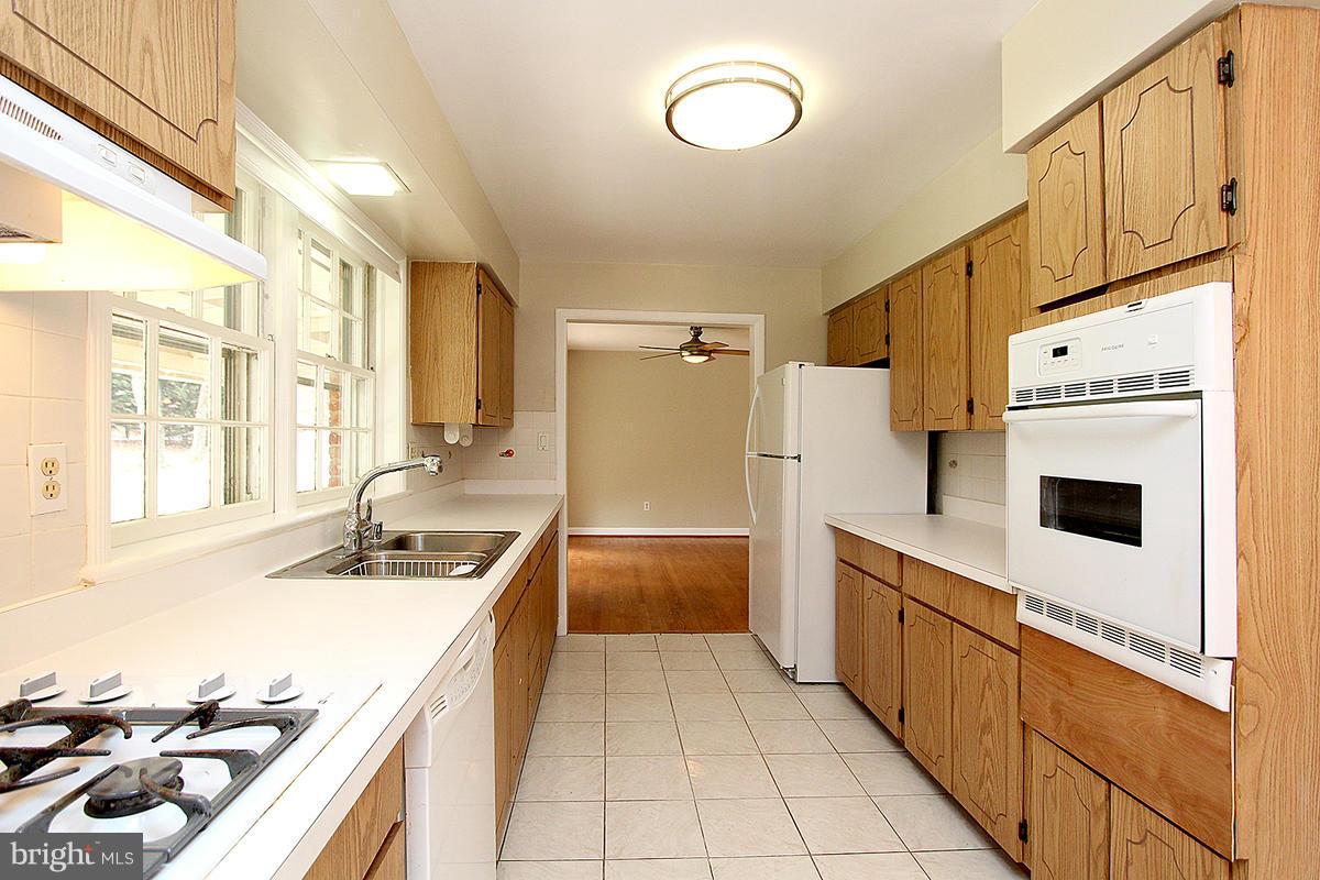 17216 Donora Road Silver Spring, MD 20905 - Photo 11 of 28 a kitchen with stainless steel appliances a stove a sink and a refrigerator