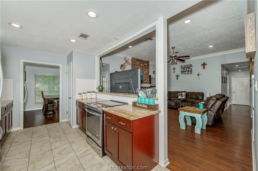 2009 Cobblestone Lane Bryan, TX 77807 - Photo 8 of 23 a kitchen with stainless steel appliances granite countertop a stove and a refrigerator