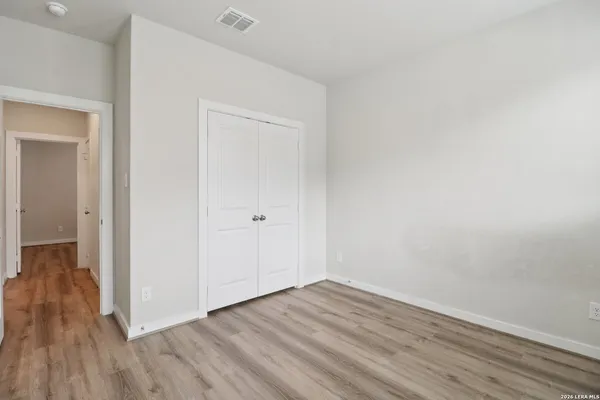 a view of a room with wooden floor