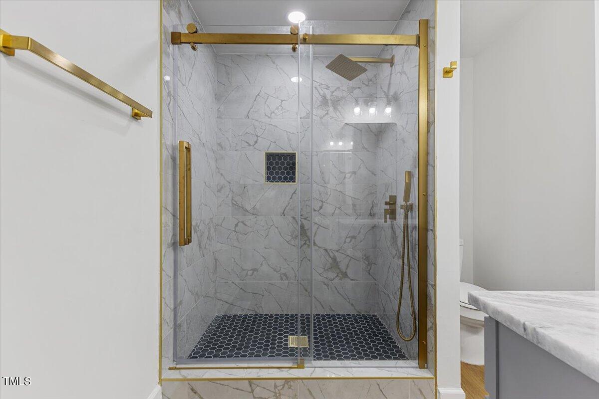 808 Edison Road Raleigh, NC 27610 - Photo 7 of 24 a bathroom with a glass shower door