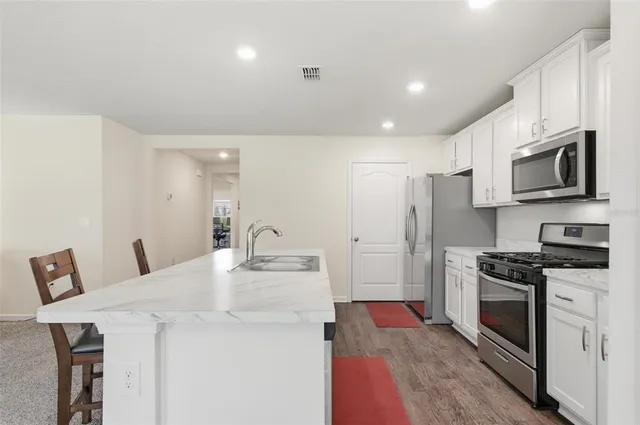 a bathroom with a granite countertop sink a toilet and a mirror