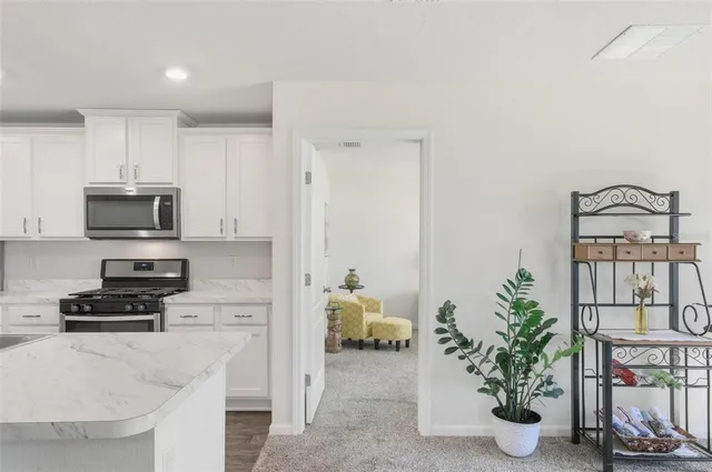 a bedroom with a bed and a flat tv screen on dresser
