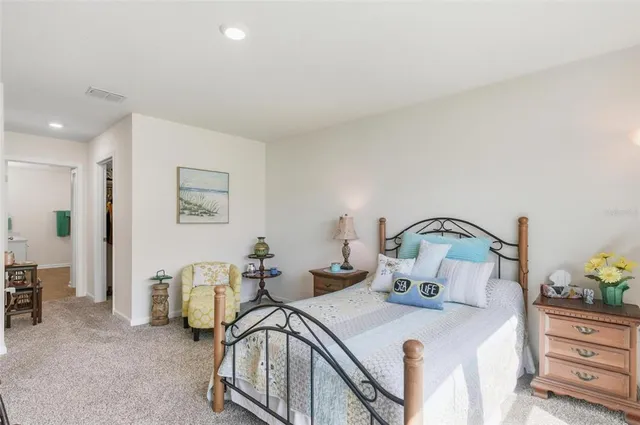 a bedroom with furniture and a large window