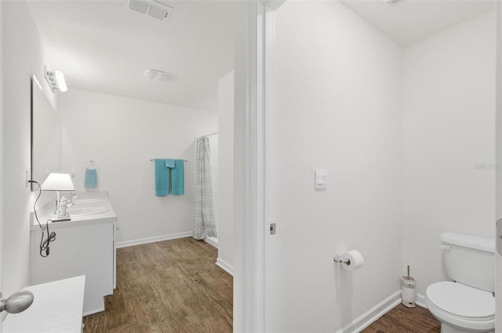 2 Pinnacle Place Bunnell, FL 32110 - Photo 35 of 83 a bathroom with a granite countertop sink a toilet and a mirror