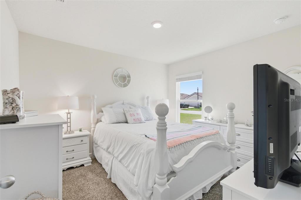 2 Pinnacle Place Bunnell, FL 32110 - Photo 48 of 83 a bedroom with a bed and a flat tv screen on dresser