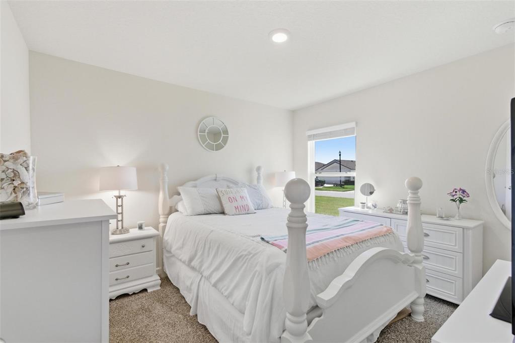 2 Pinnacle Place Bunnell, FL 32110 - Photo 49 of 83 a bedroom with a bed and a lamp with the dresser