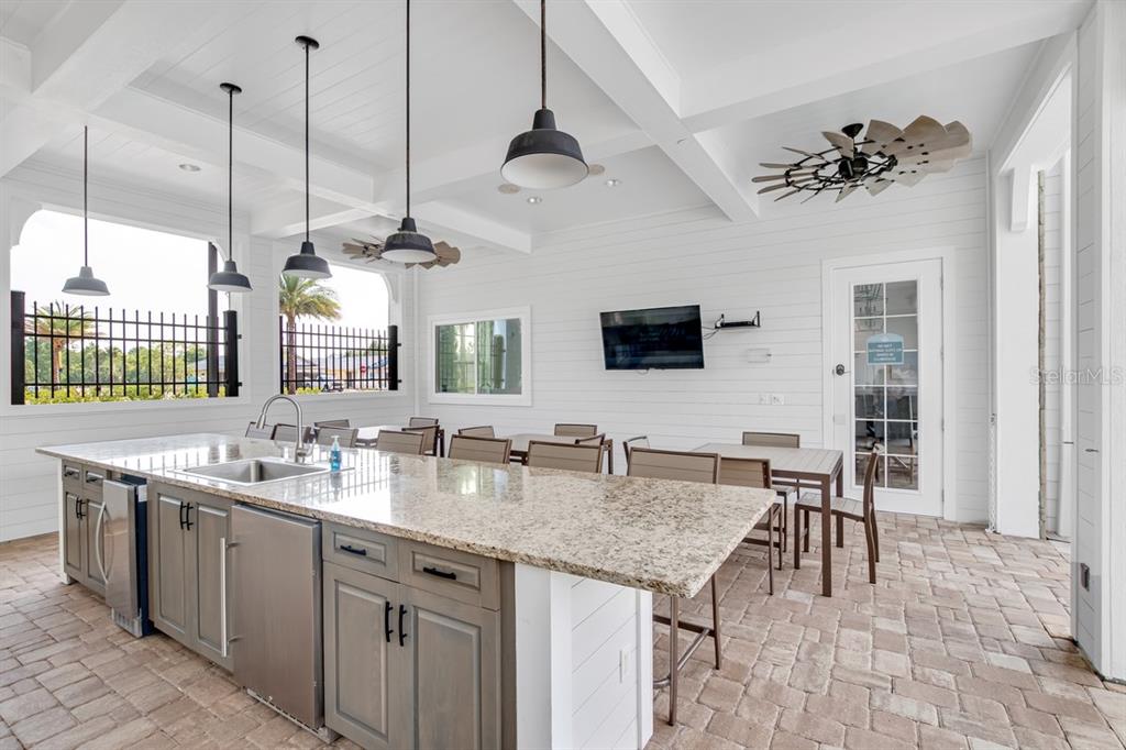 2 Pinnacle Place Bunnell, FL 32110 - Photo 77 of 83 a kitchen with a table center island a sink stainless steel appliances and a window