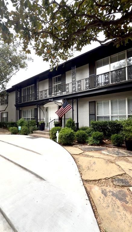 8545 Pickwick Lane, Unit D Dallas, TX 75225 - Photo 1 of 1 a front view of a house with a yard