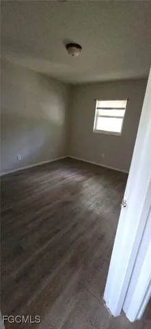 a view of wooden floor and windows in an empty room