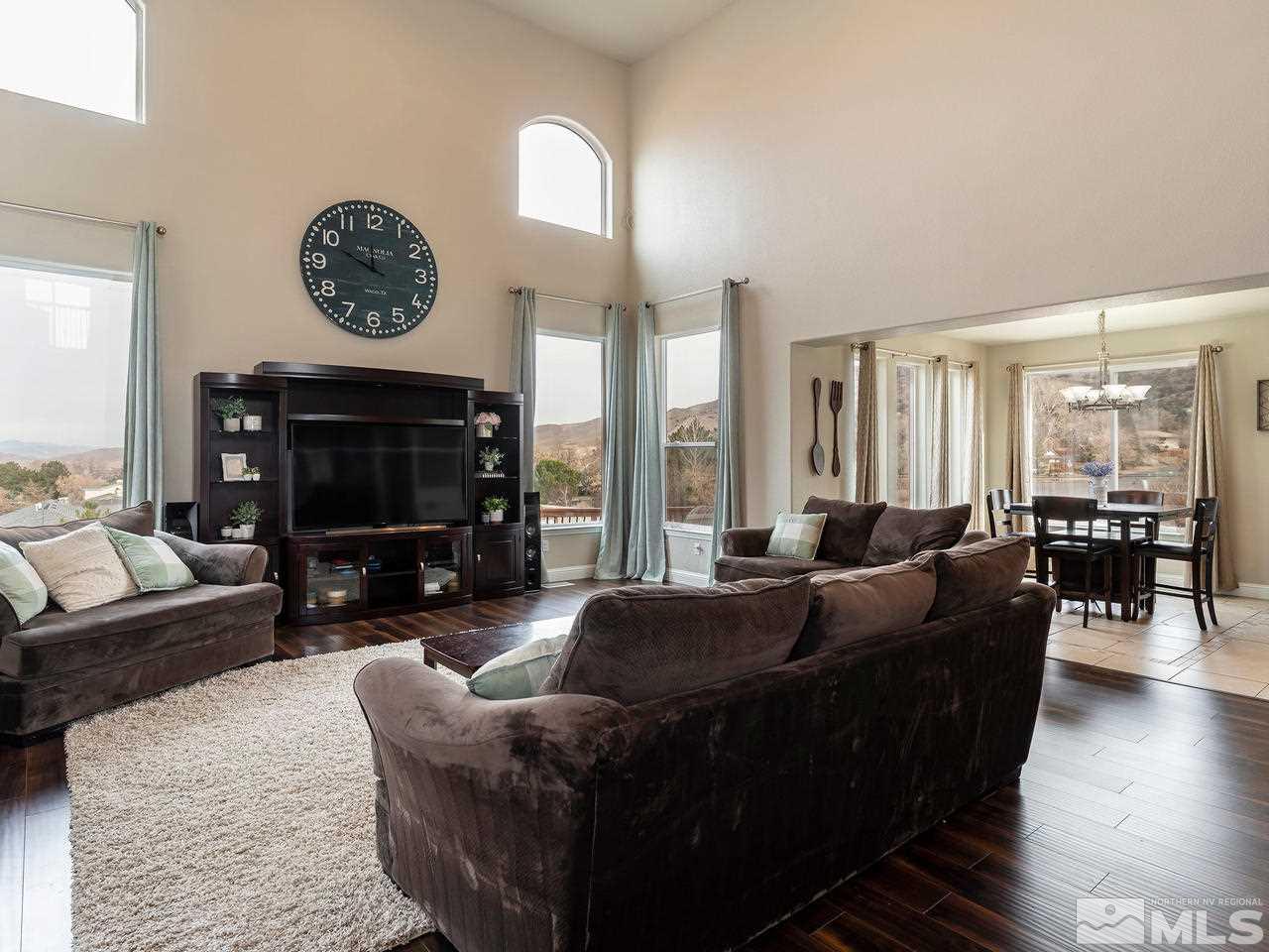 13520 Rim Rock Drive Reno, NV 89521 - Photo 14 of 25 a living room with fireplace furniture and a large window