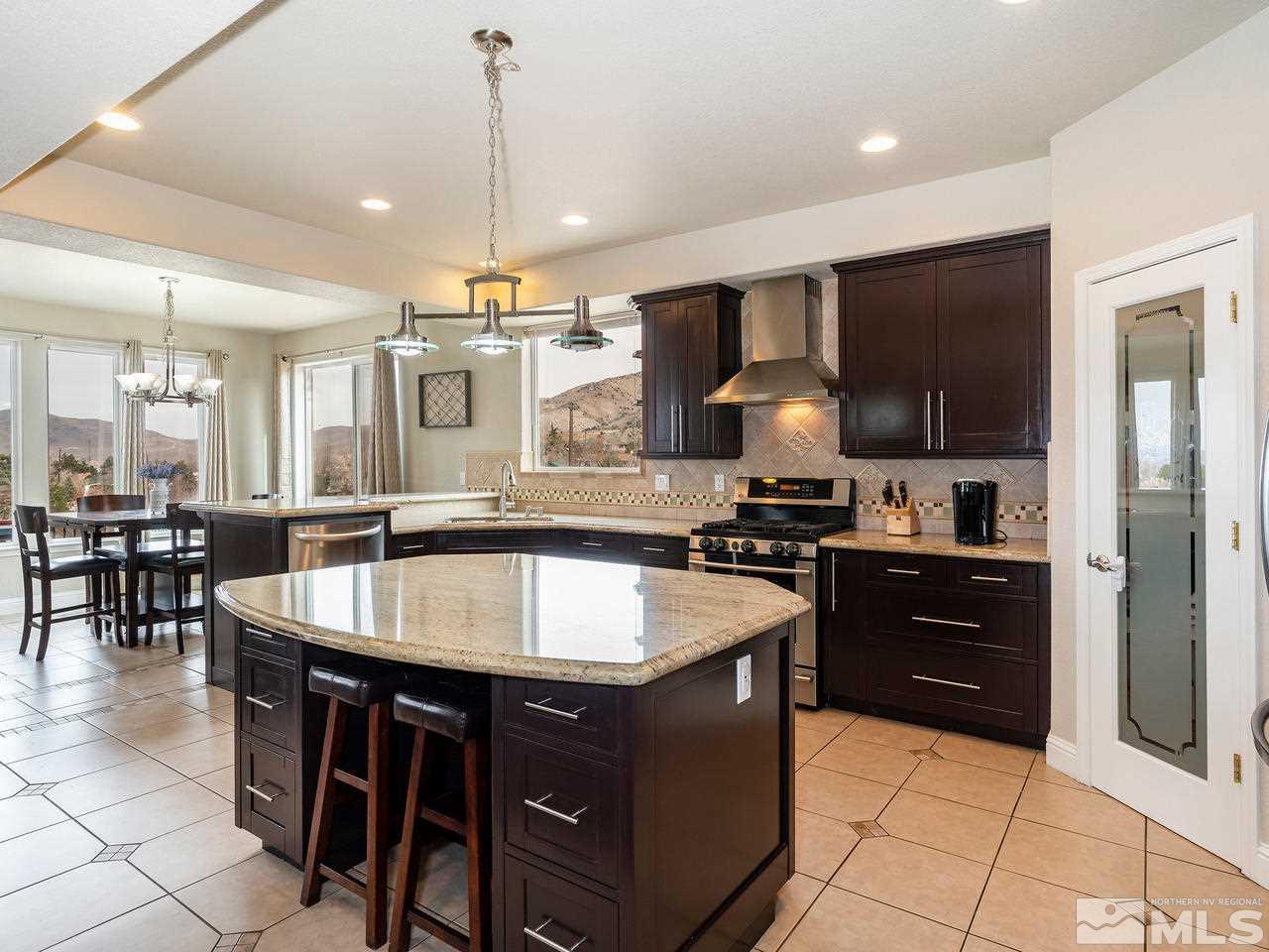 13520 Rim Rock Drive Reno, NV 89521 - Photo 17 of 25 a large kitchen with a table and chairs