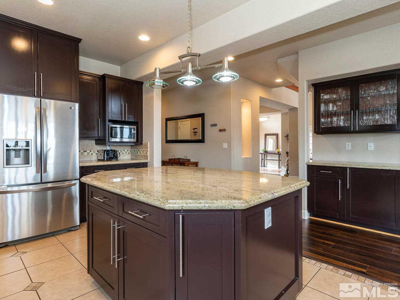 13520 Rim Rock Drive Reno, NV 89521 - Photo 19 of 25 a kitchen with stainless steel appliances granite countertop a sink a refrigerator and a microwave
