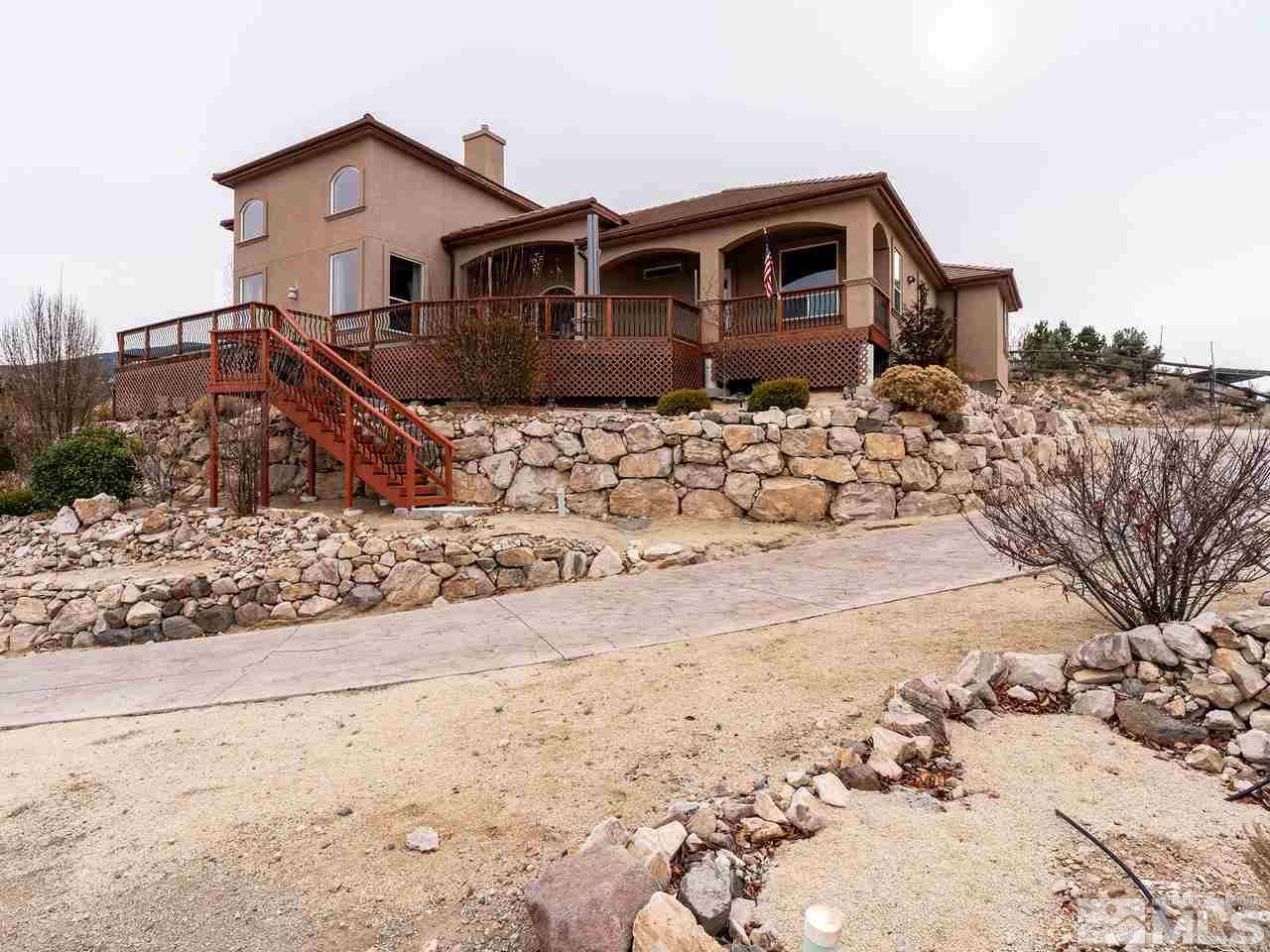 13520 Rim Rock Drive Reno, NV 89521 - Photo 4 of 25 a front view of a house with a yard covered in snow