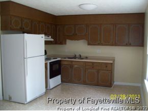 31 Arabian Drive Spring Lake, NC 28390 - Photo 5 of 10 a kitchen with a refrigerator and a stove