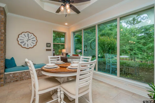 a dining room with a large window and table