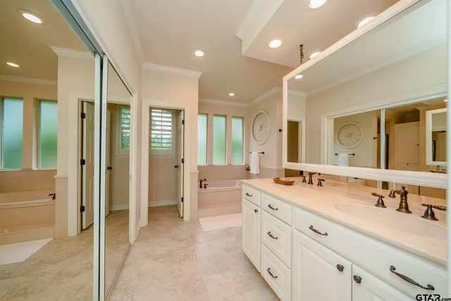 a bathroom with a tub and a mirror