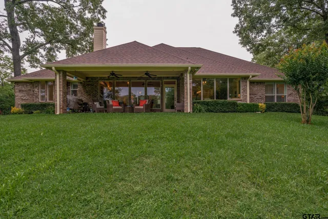a view of a porch with furniture and garden
