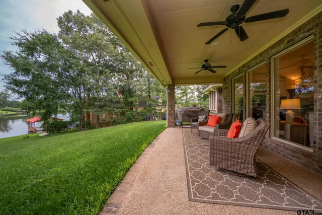 a front view of a house with a yard and swimming pool