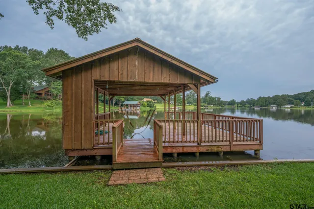 a view of a deck with wooden floor and backyard
