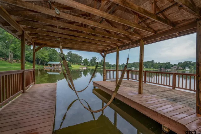 an aerial view of green landscape with trees houses and lake view