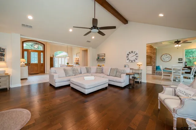 a living room with furniture a fireplace and a large window