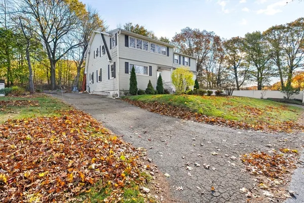 a view of a house with a yard and tree s