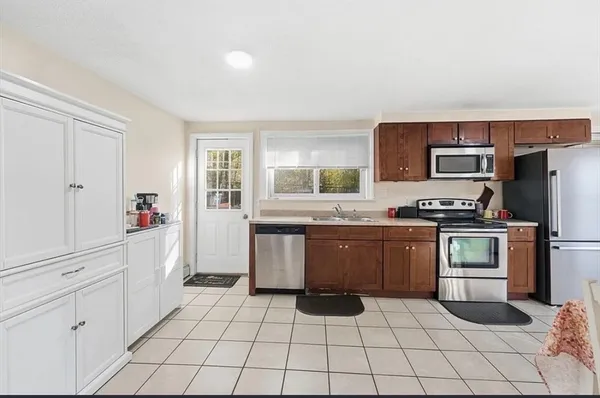 a kitchen with a stove a sink and a refrigerator