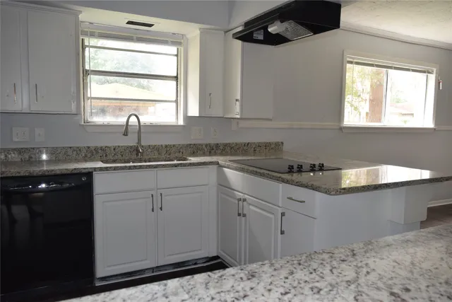 a kitchen with granite countertop a sink and a window