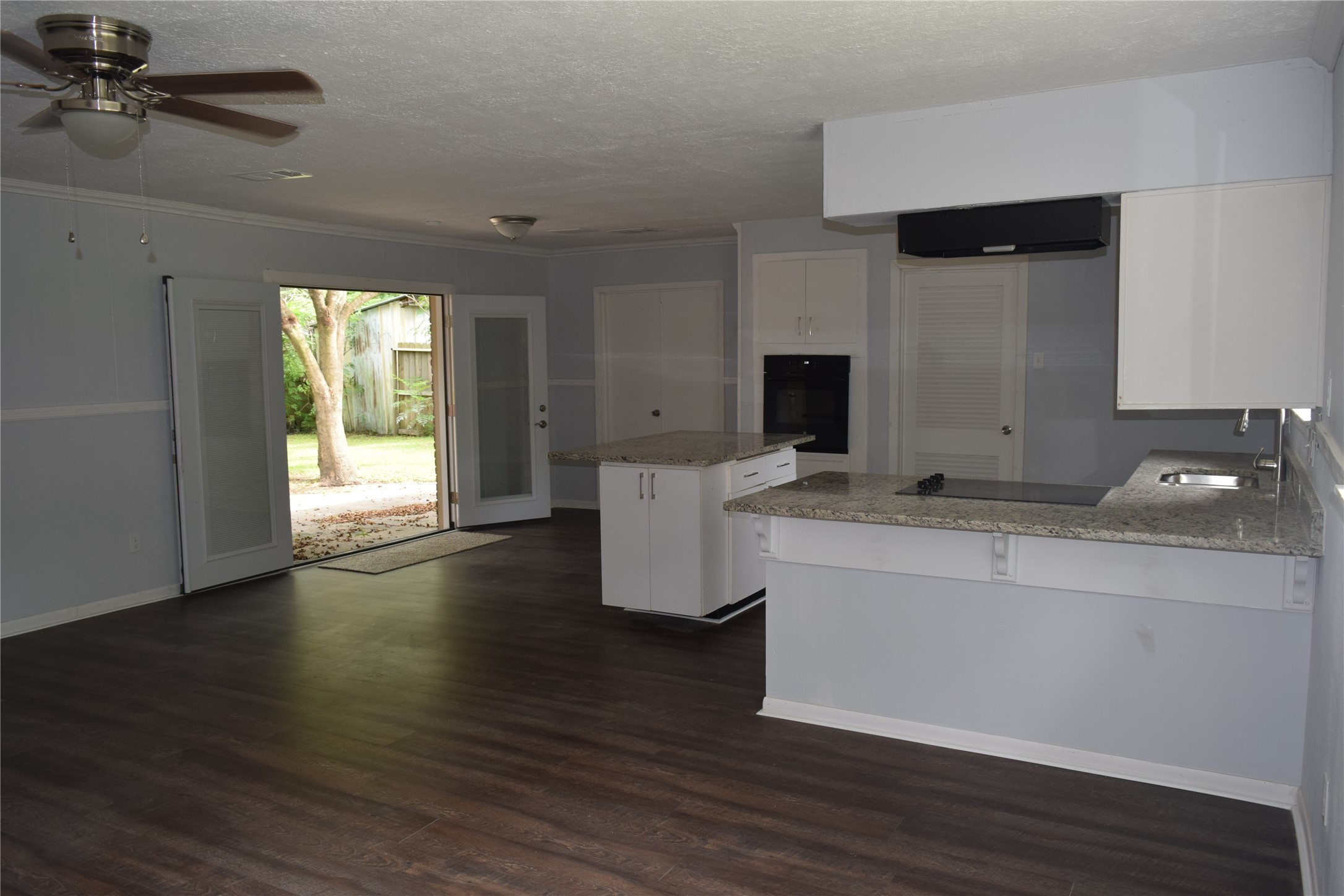 9902 Tolman Street Houston, TX 77034 - Photo 12 of 26 a room with a chandelier and wooden floor