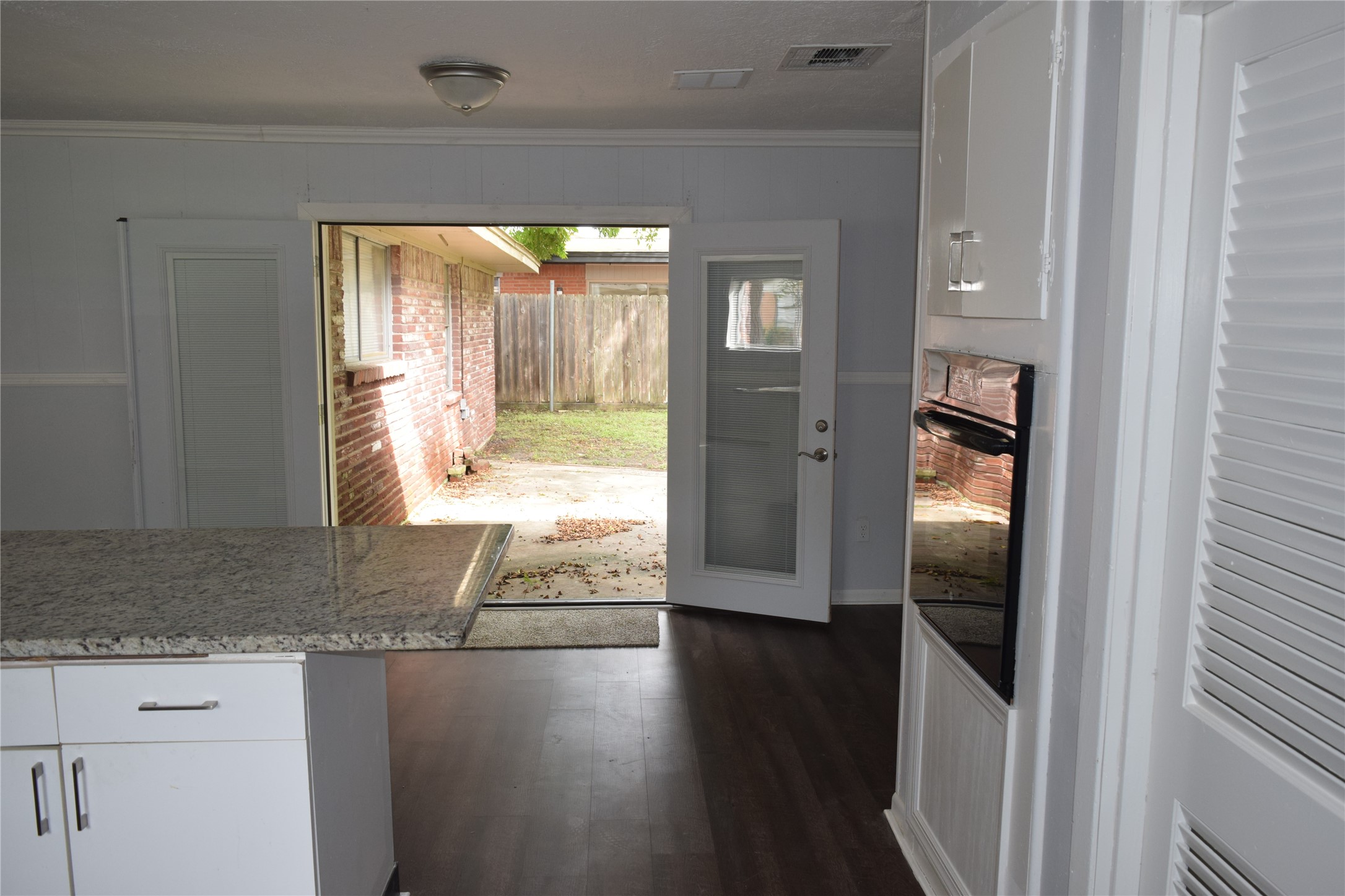 9902 Tolman Street Houston, TX 77034 - Photo 15 of 26 a view of a hallway with wooden floor and a living room