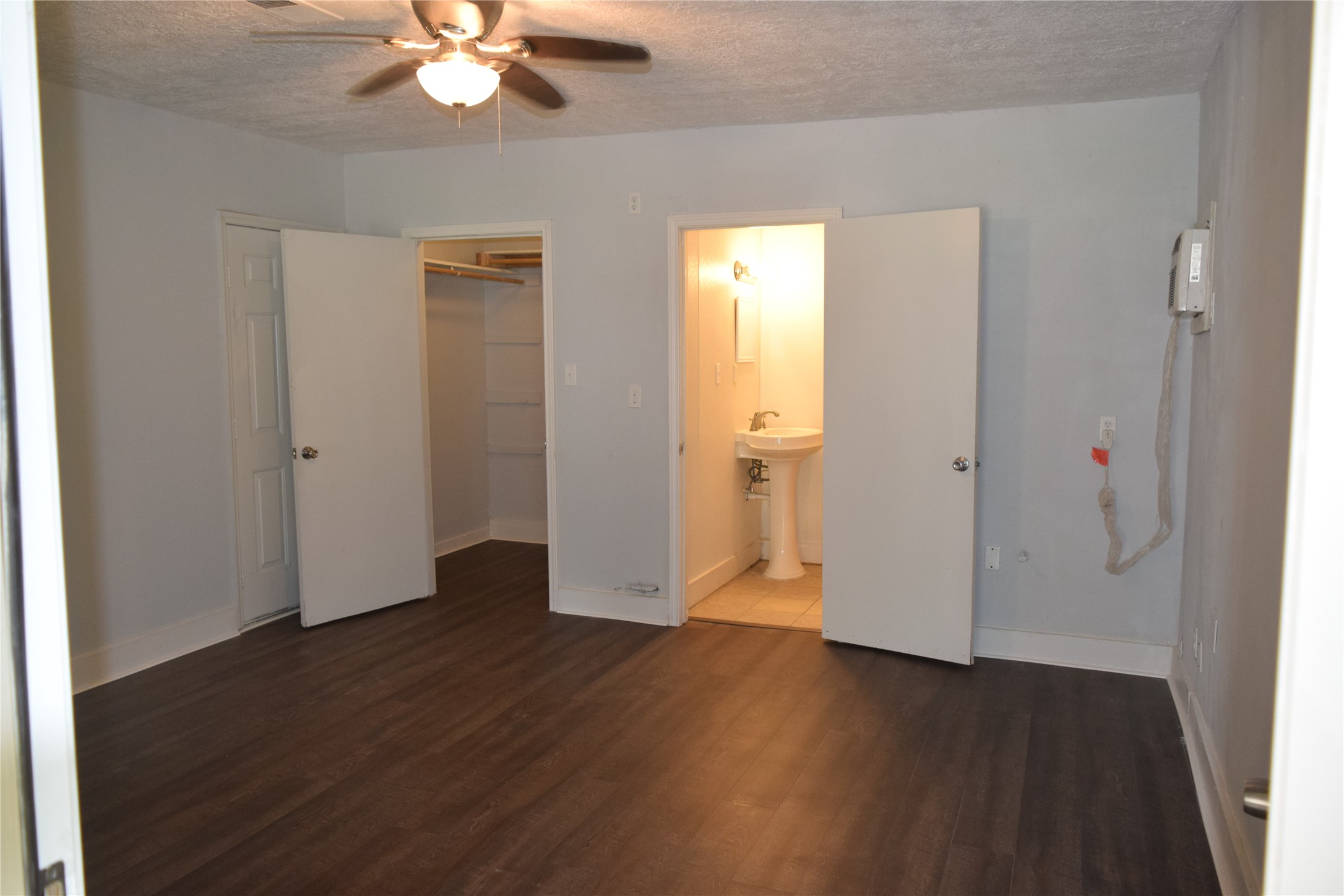 9902 Tolman Street Houston, TX 77034 - Photo 18 of 26 an empty room with wooden floor and a ceiling fan