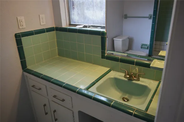 a bathroom with a sink and a mirror