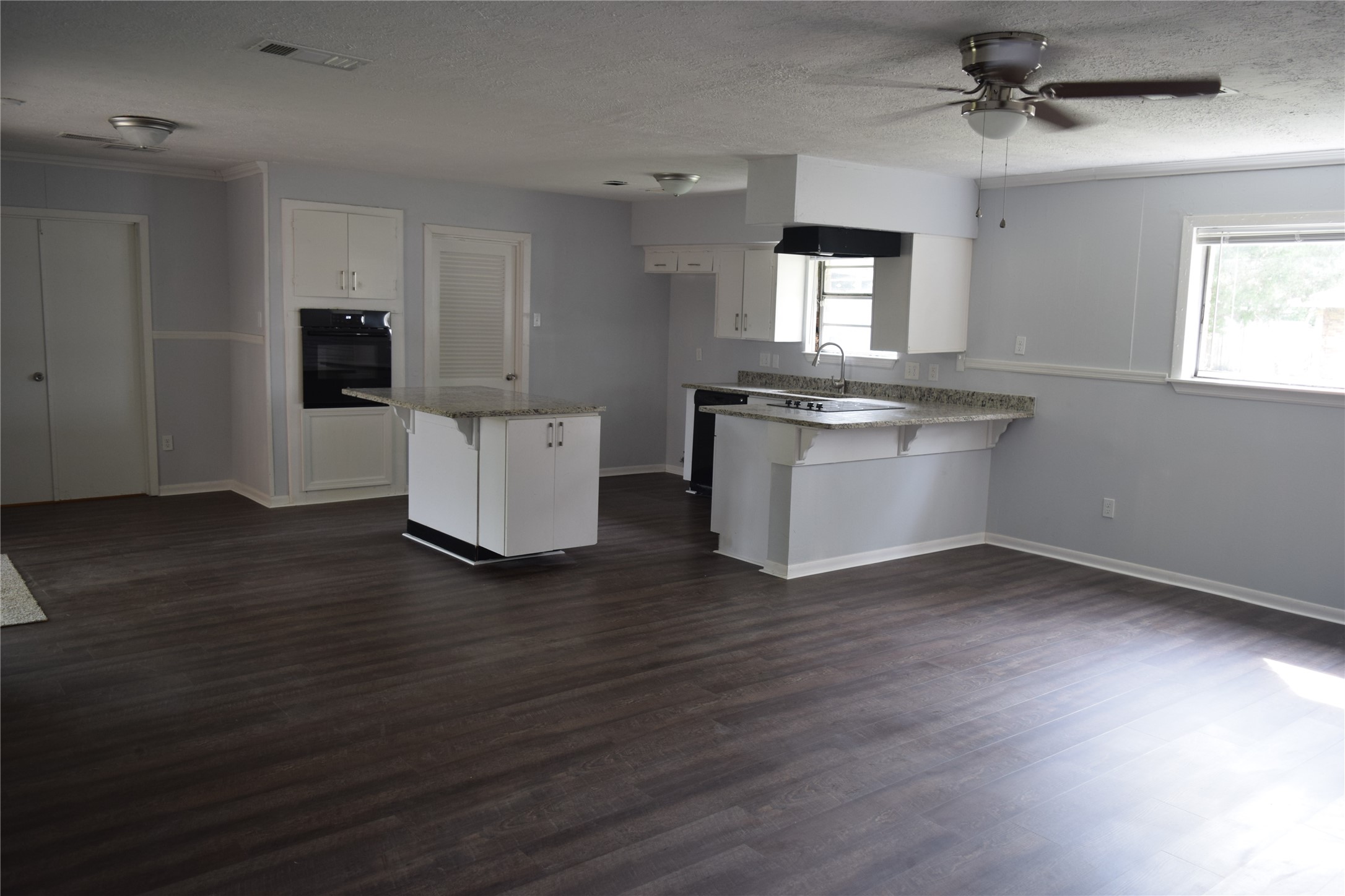9902 Tolman Street Houston, TX 77034 - Photo 10 of 26 an empty room with wooden floor and windows