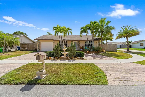 a view of a house with swimming pool and a yard