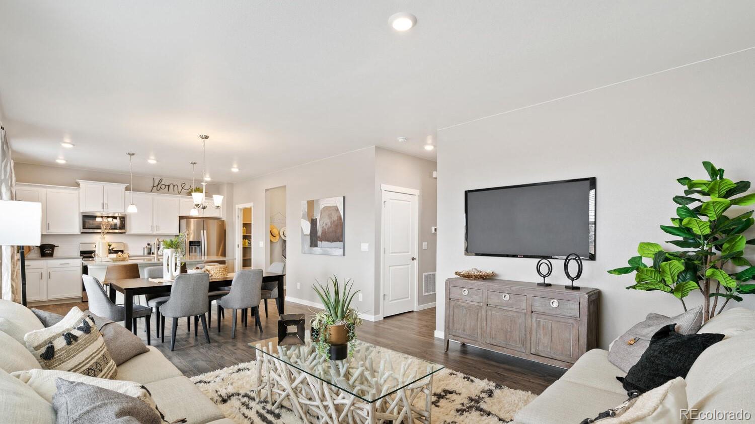 1531 Pinnacle Avenue Lochbuie, CO 80603 - Photo 4 of 25 a living room with furniture and a flat screen tv