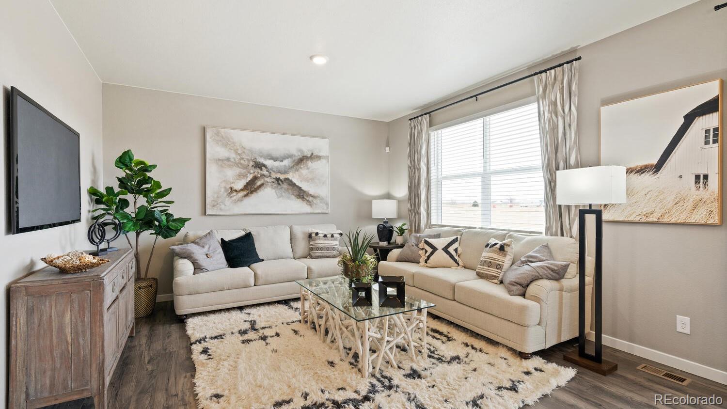 1531 Pinnacle Avenue Lochbuie, CO 80603 - Photo 7 of 25 a living room with furniture and a large window