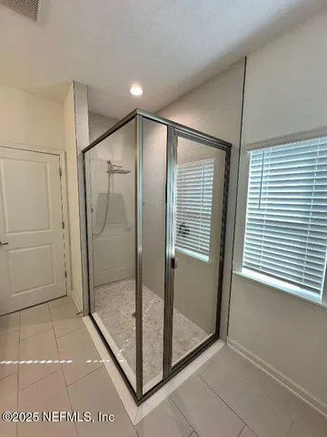 a bathroom with a glass shower door
